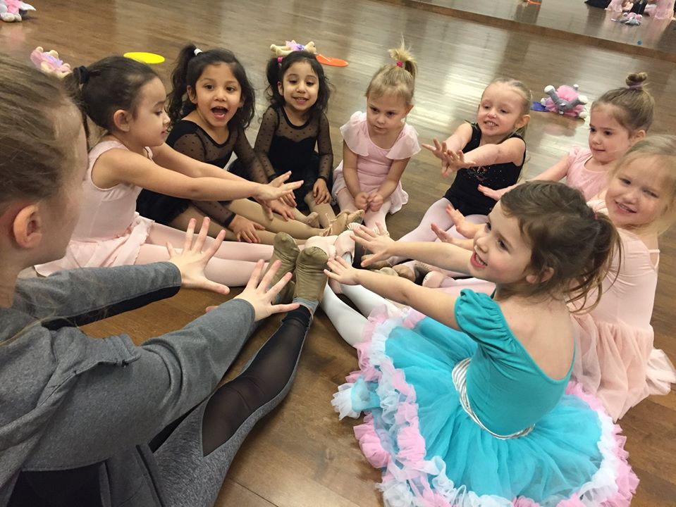 Group of happy girls stretching