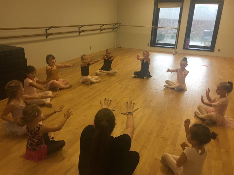 Children stretching together in a circle